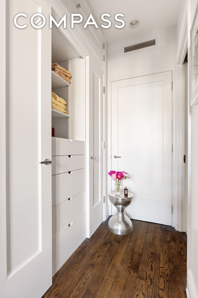 corridor featuring recessed lighting, visible vents, and dark wood-type flooring