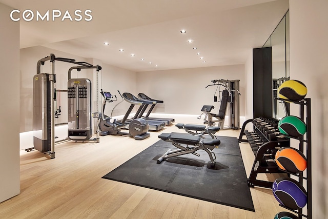 workout room featuring recessed lighting and wood finished floors