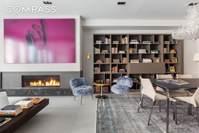 living area featuring a notable chandelier and a high end fireplace