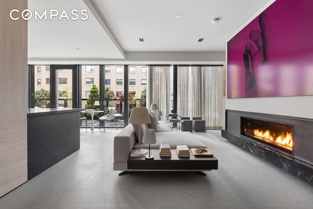 interior space featuring a glass covered fireplace and beamed ceiling