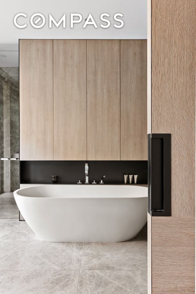 bathroom featuring a soaking tub