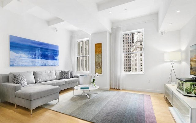 living area featuring recessed lighting, baseboards, and light wood-type flooring