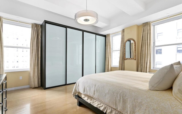 bedroom with baseboards and light wood-type flooring