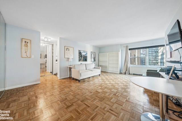 unfurnished living room featuring baseboards