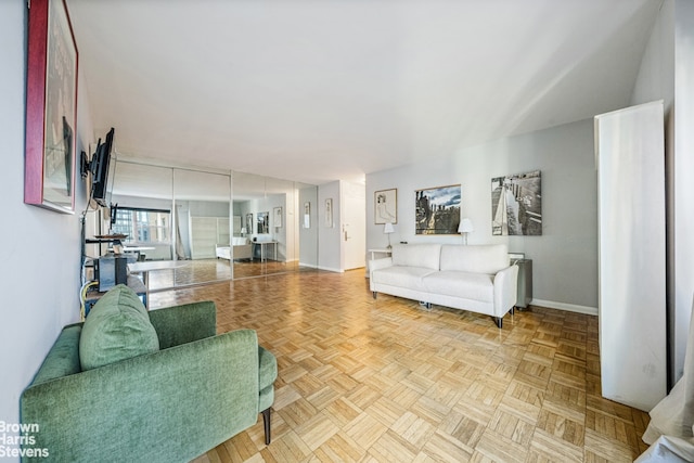 living area featuring baseboards