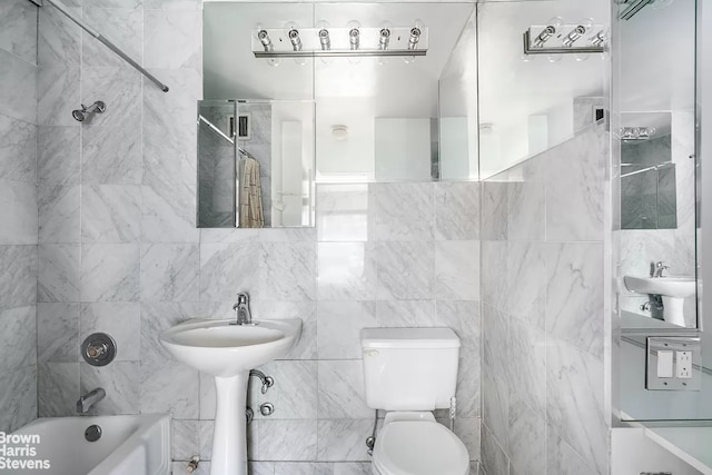 bathroom with toilet, bathtub / shower combination, and a sink