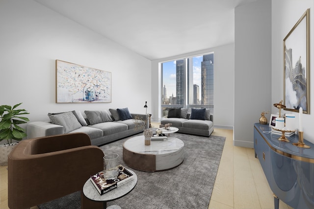living room featuring a view of city, floor to ceiling windows, and light wood-style flooring