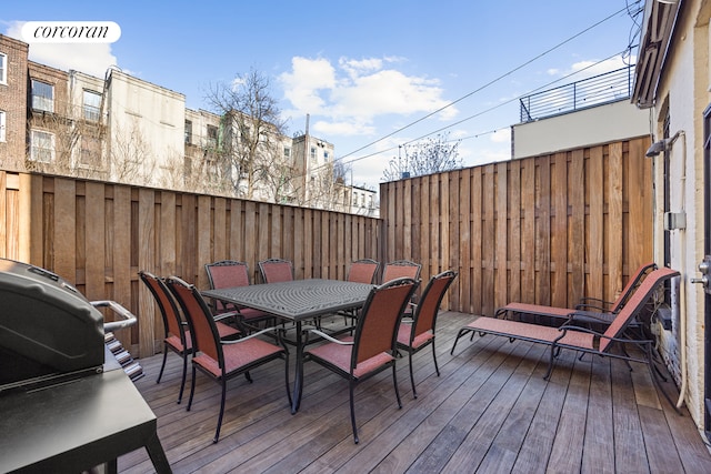 deck with outdoor dining space and fence