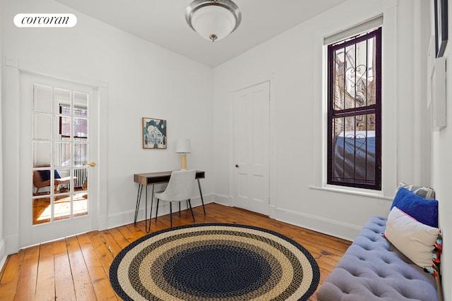 home office with visible vents, baseboards, and hardwood / wood-style floors