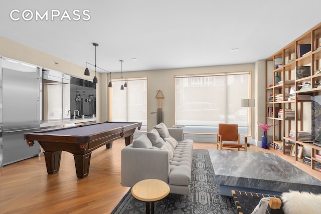 recreation room with billiards and light wood-style floors