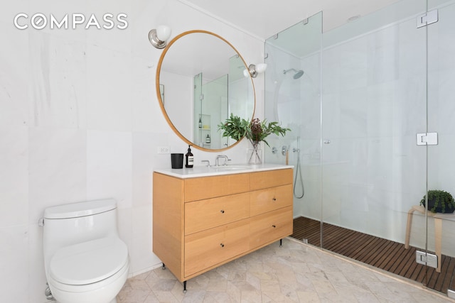 bathroom with a shower stall, toilet, and vanity