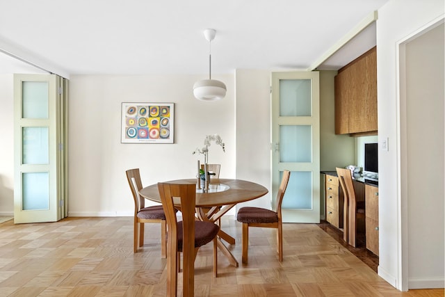 dining area featuring baseboards