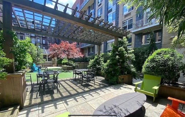 view of patio featuring outdoor dining area and a pergola