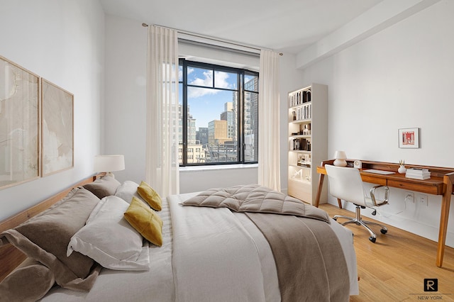 110 Charlton St Unit 20-G, New York City, NY 10014 - bedroom with wood finished floors, a city view, and a desk