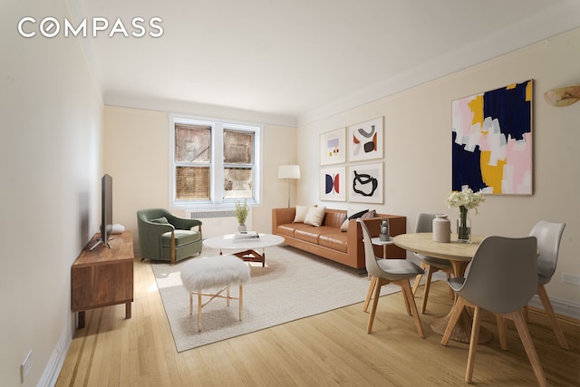 living area featuring baseboards and wood finished floors