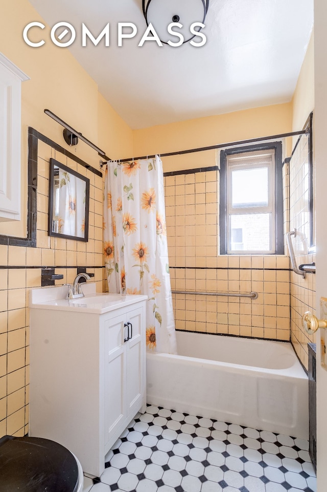 bathroom featuring vanity, tile patterned floors, tile walls, and shower / bath combo