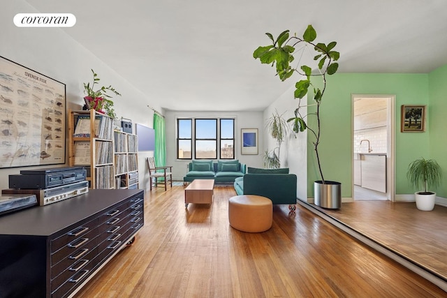 living room featuring hardwood / wood-style flooring, baseboards, and visible vents