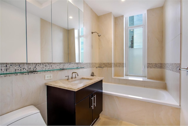 bathroom featuring a wealth of natural light, toilet, tile walls, and vanity