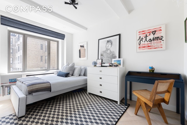 bedroom with beamed ceiling and multiple windows