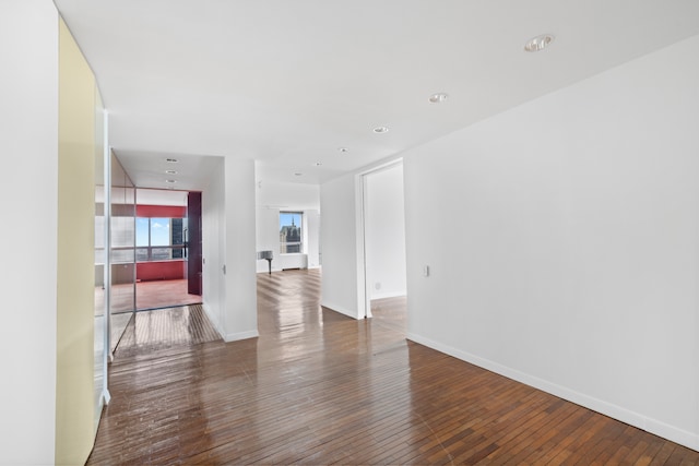 empty room featuring baseboards and wood-type flooring