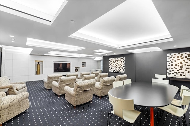 interior space with a tray ceiling and carpet flooring