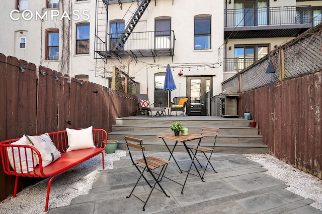 view of patio / terrace with an outdoor hangout area, a balcony, and a fenced backyard