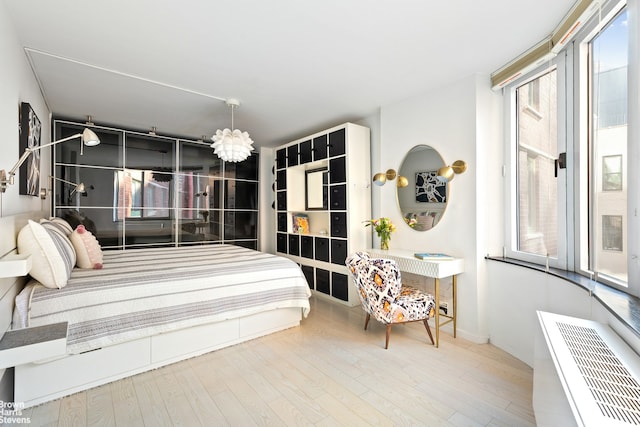 bedroom with baseboards and wood finished floors