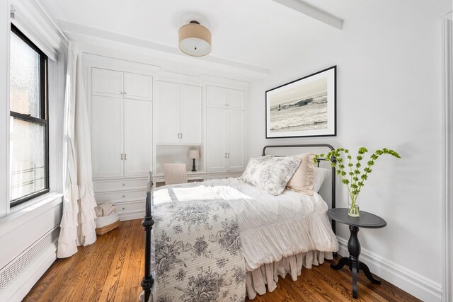 119 E 84th St Unit 4C, New York City, NY 10028 - bedroom featuring multiple windows, wood finished floors, and baseboards