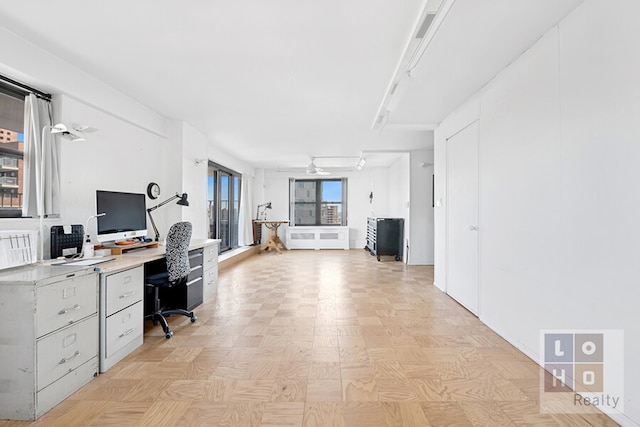 home office featuring ceiling fan and built in study area