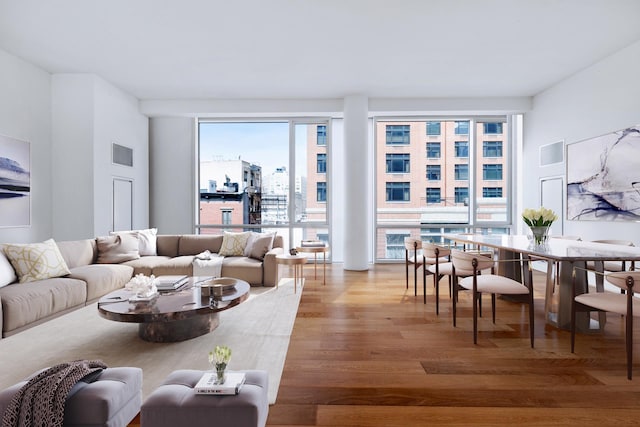 living area featuring visible vents and light wood-style floors