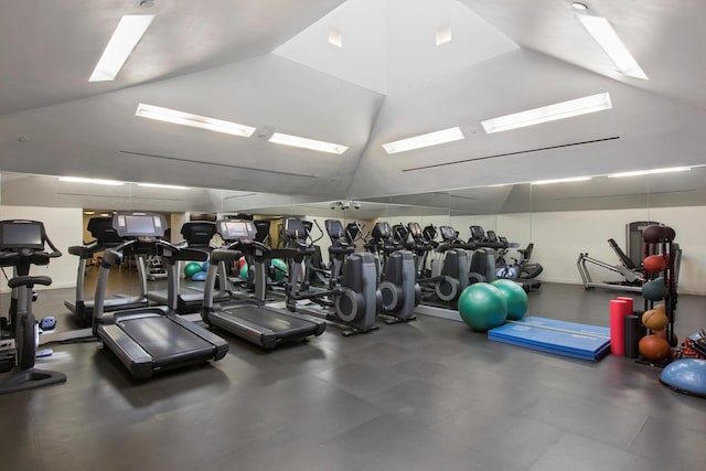 workout area with lofted ceiling with skylight