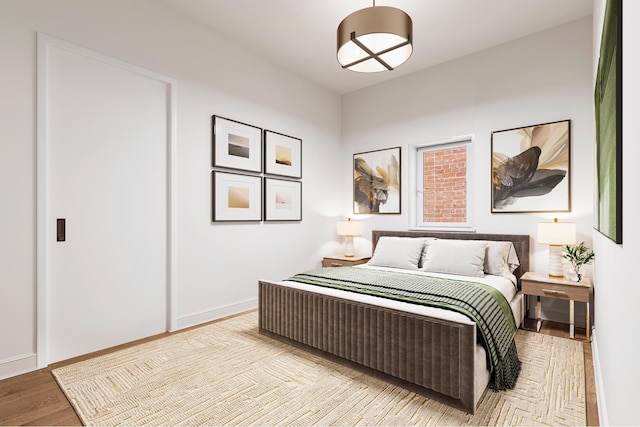 bedroom featuring baseboards and wood finished floors