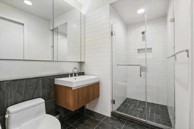 full bathroom featuring a shower stall, tile walls, toilet, tile patterned floors, and vanity