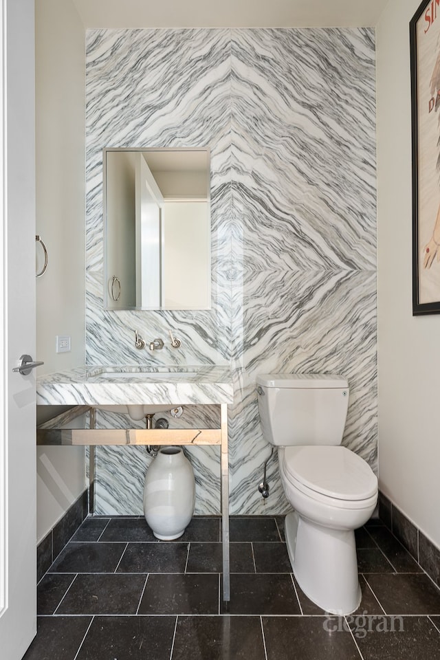 bathroom featuring tile patterned flooring and toilet