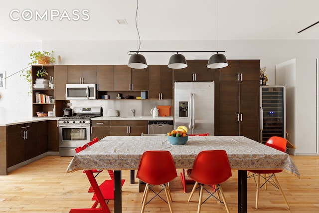 kitchen featuring open shelves, wine cooler, light countertops, and stainless steel appliances