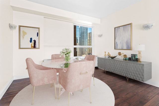 dining area featuring baseboards and wood finished floors