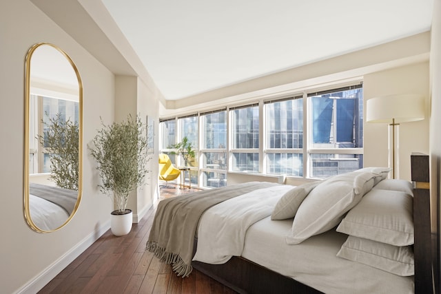 146 W 57th St Unit 34A, New York City, NY 10019 - bedroom featuring dark wood-type flooring and baseboards