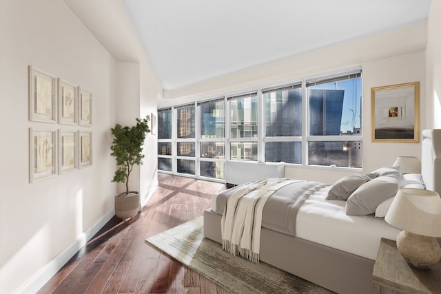 bedroom with baseboards and dark wood-style floors