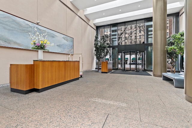 lobby featuring a towering ceiling and recessed lighting