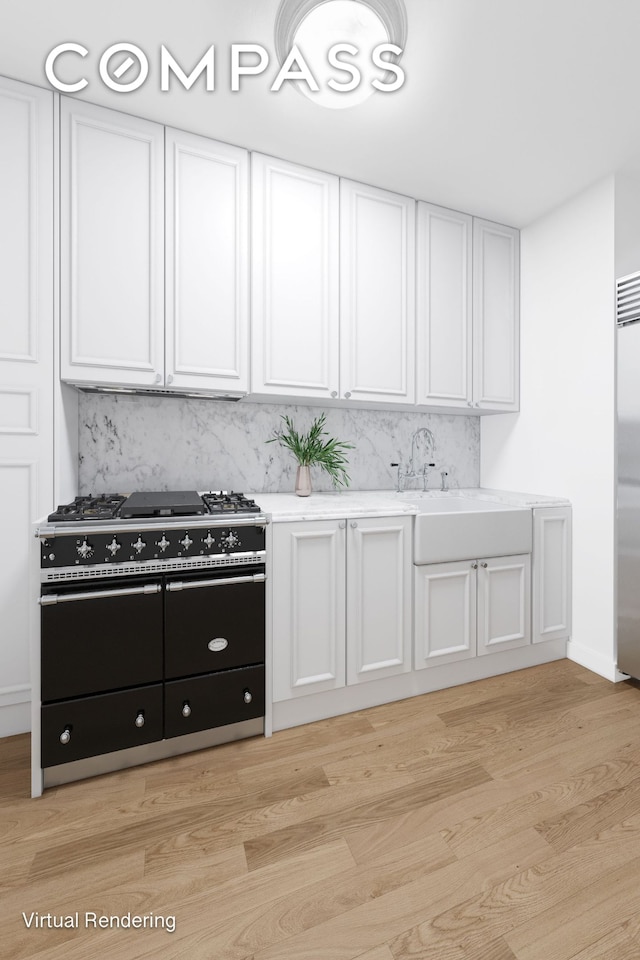 kitchen featuring light countertops, white cabinets, premium appliances, and light wood-type flooring