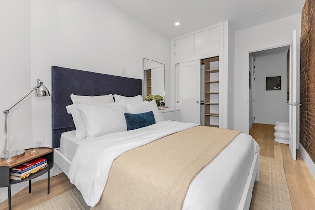 bedroom featuring a closet, recessed lighting, and light wood-style floors