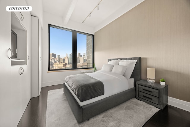 70 Washington St Unit 9G, New York City, NY 11201 - bedroom featuring wood finished floors, baseboards, rail lighting, and a view of city