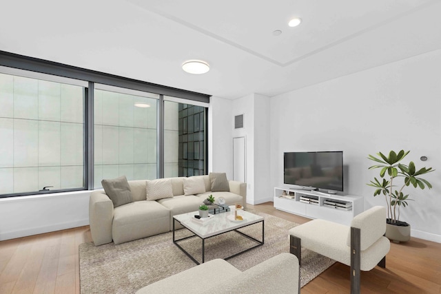 living area with visible vents, recessed lighting, baseboards, and wood finished floors