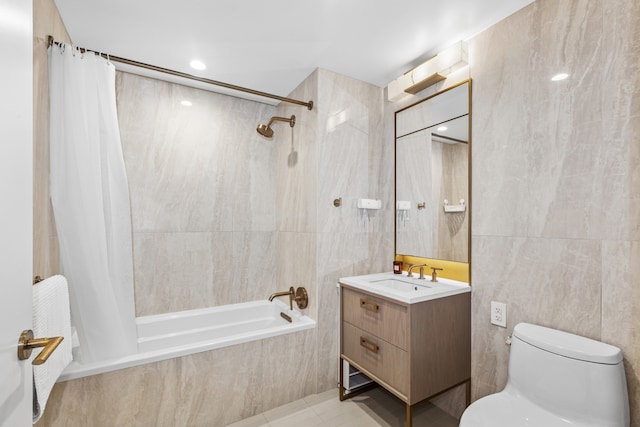 bathroom with tiled shower / bath combo, toilet, tile walls, and vanity