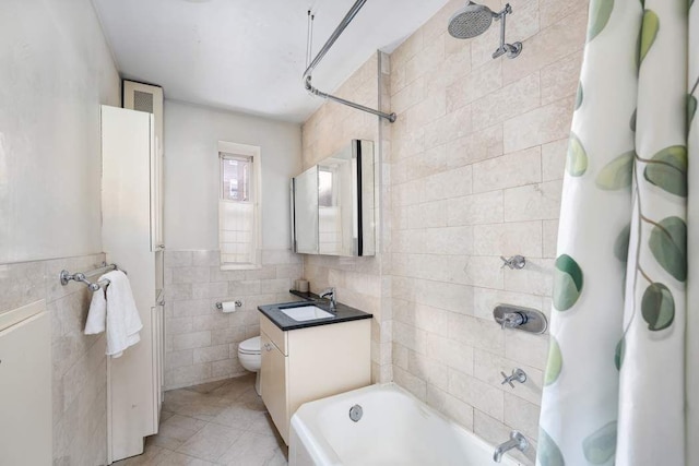 bathroom featuring tile patterned flooring, tile walls, toilet, shower / tub combo with curtain, and vanity