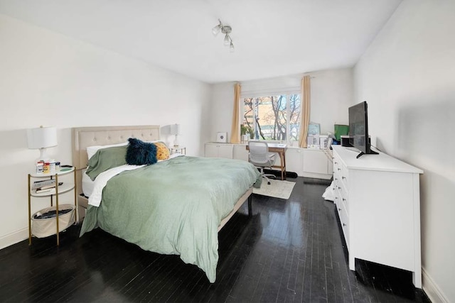 bedroom featuring dark wood finished floors and baseboards