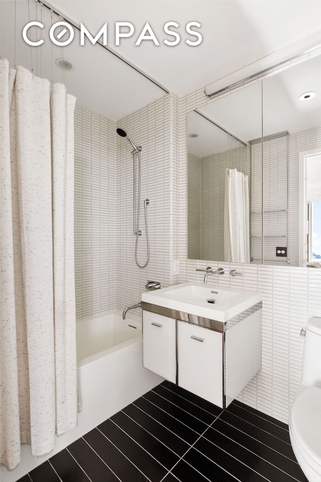 full bathroom with toilet, shower / bath combo with shower curtain, and vanity