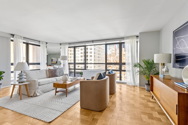 living room with plenty of natural light, baseboards, and expansive windows