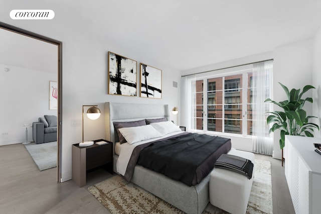 bedroom with visible vents and wood finished floors