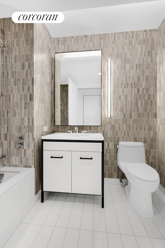 bathroom with toilet, tiled shower / bath combo, tile walls, tile patterned flooring, and vanity